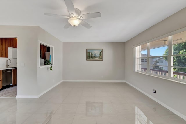 unfurnished room featuring sink, light tile patterned flooring, and ceiling fan