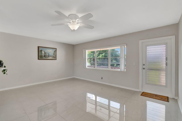 unfurnished room featuring ceiling fan and light tile patterned flooring