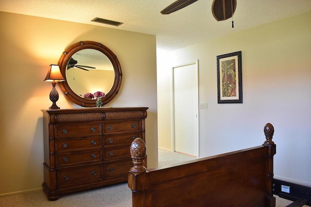 carpeted bedroom with a textured ceiling and ceiling fan