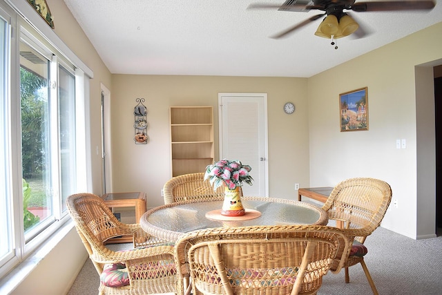 dining area with a textured ceiling and carpet floors