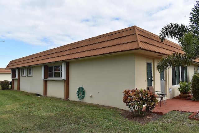 view of property exterior featuring a yard