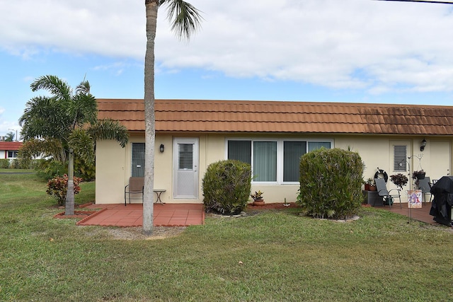 rear view of house with a lawn