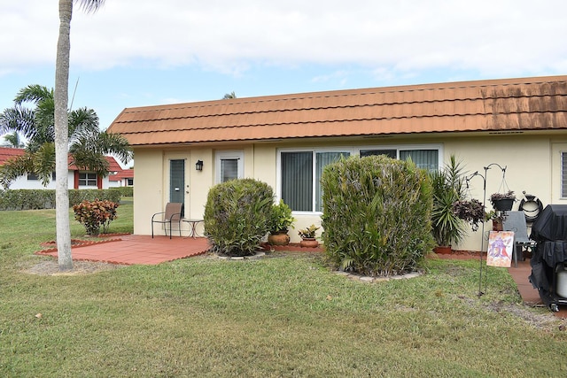 rear view of property featuring a yard