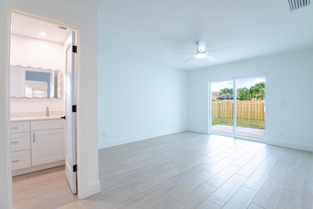 empty room with ceiling fan and sink