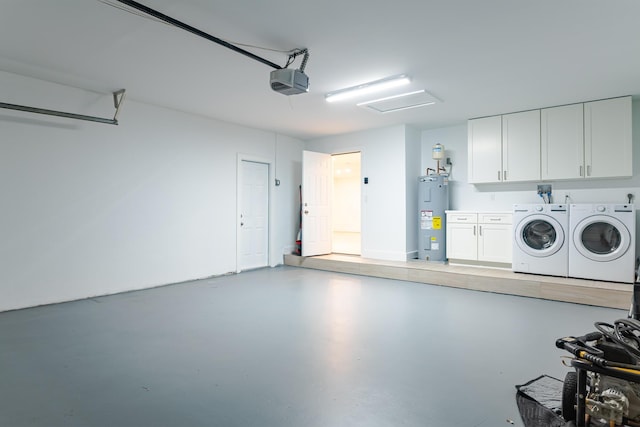 garage featuring electric water heater, a garage door opener, and washing machine and clothes dryer