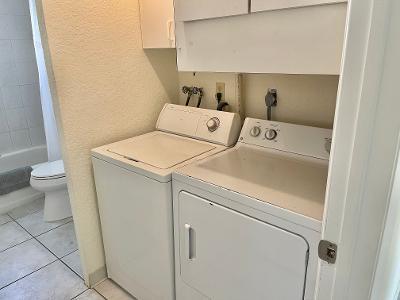 laundry area featuring washer and dryer and light tile patterned floors