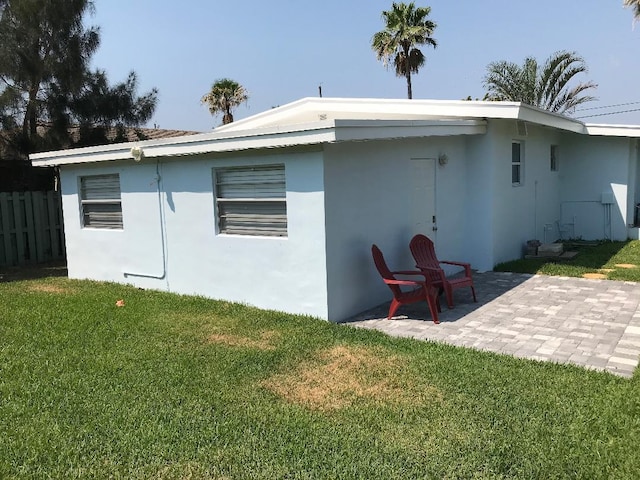 back of house featuring a yard and a patio