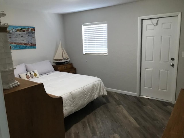 bedroom with dark hardwood / wood-style flooring