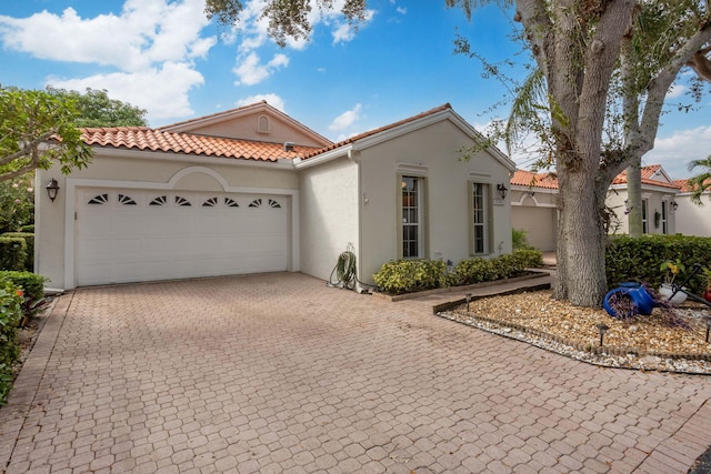 mediterranean / spanish home featuring a garage