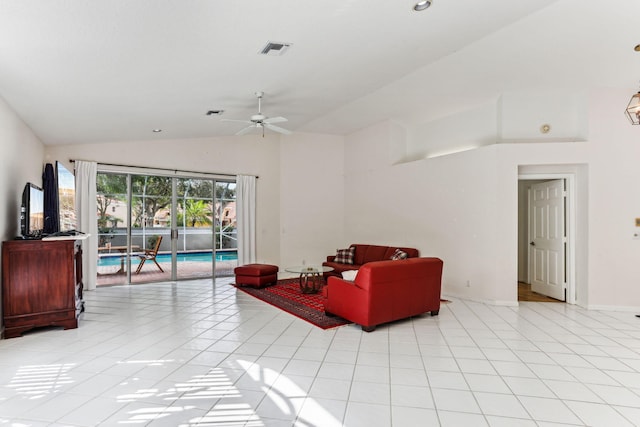 living room with ceiling fan, lofted ceiling, and light tile patterned floors