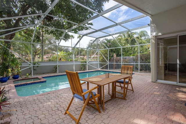 view of swimming pool featuring glass enclosure and a patio area