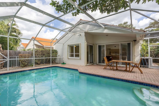 view of swimming pool featuring a patio area and a lanai