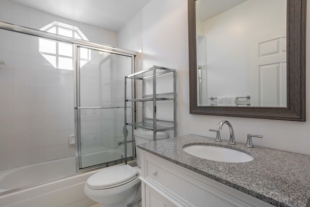 full bathroom with vanity, toilet, and bath / shower combo with glass door