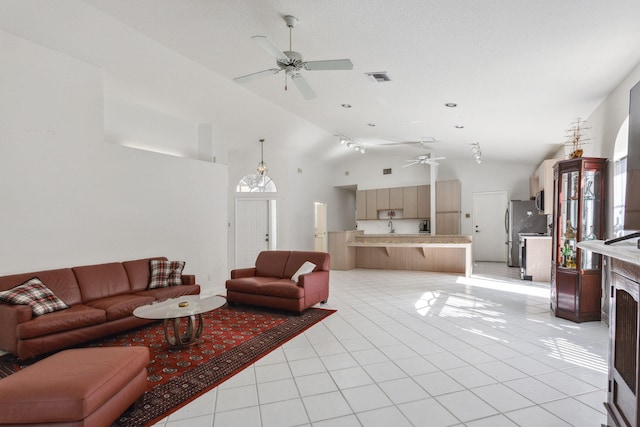 living room featuring ceiling fan, light tile patterned flooring, and high vaulted ceiling