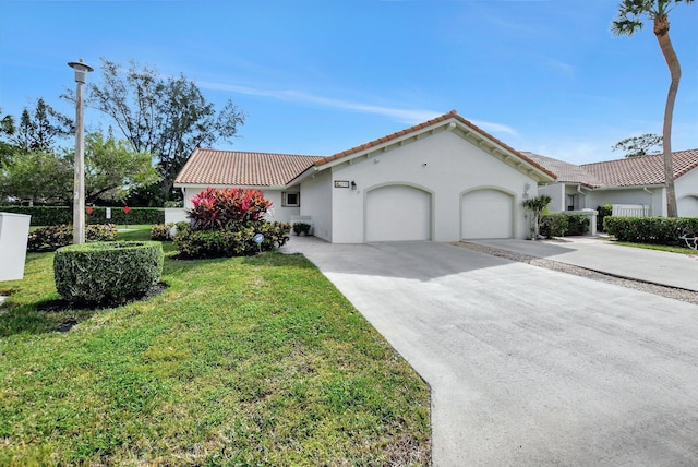 mediterranean / spanish-style house with a front yard and a garage