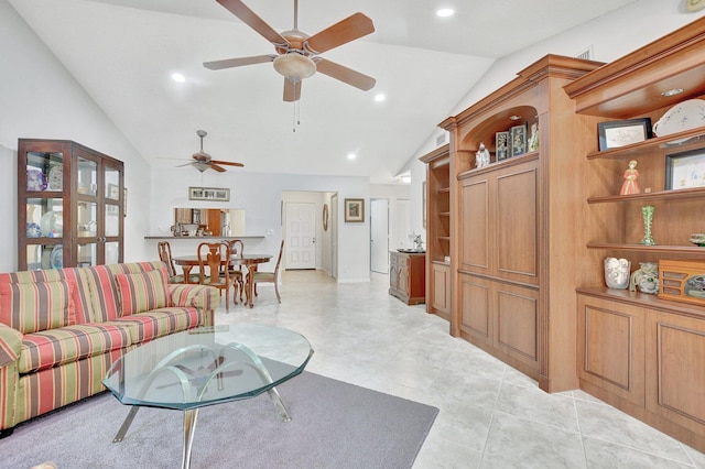 living room with ceiling fan and high vaulted ceiling