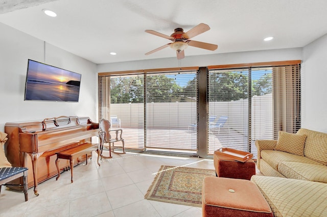 tiled living room featuring ceiling fan