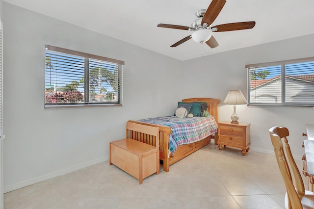 bedroom featuring multiple windows, ceiling fan, and light tile patterned floors