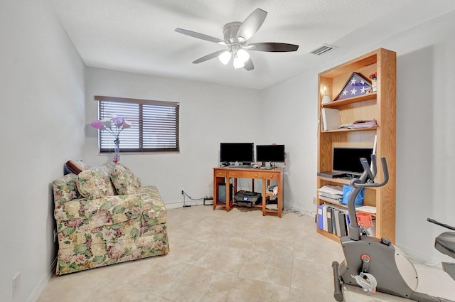 tiled office space featuring ceiling fan and a textured ceiling