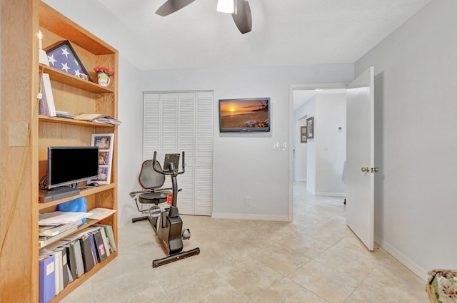 workout room featuring light tile patterned floors and ceiling fan