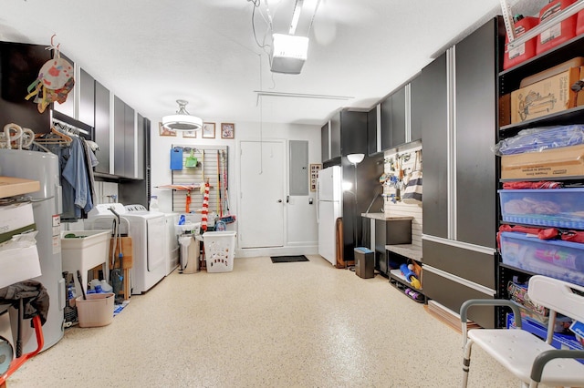 garage featuring separate washer and dryer, water heater, electric panel, white fridge, and a garage door opener