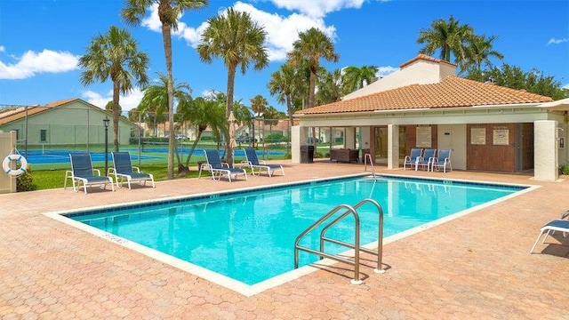 view of pool with tennis court