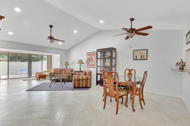 tiled dining space with ceiling fan and high vaulted ceiling