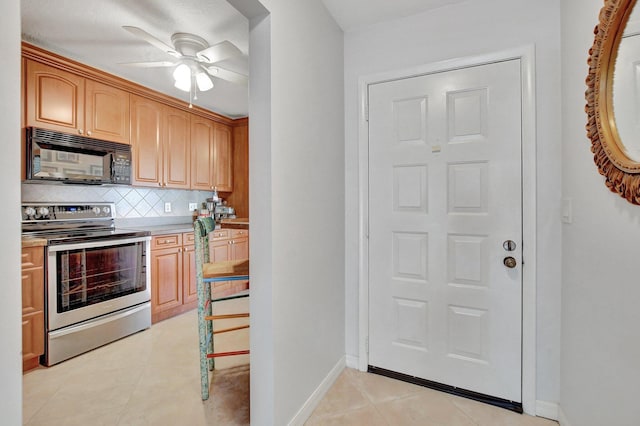 kitchen featuring ceiling fan, backsplash, stainless steel range with electric stovetop, and light tile patterned flooring