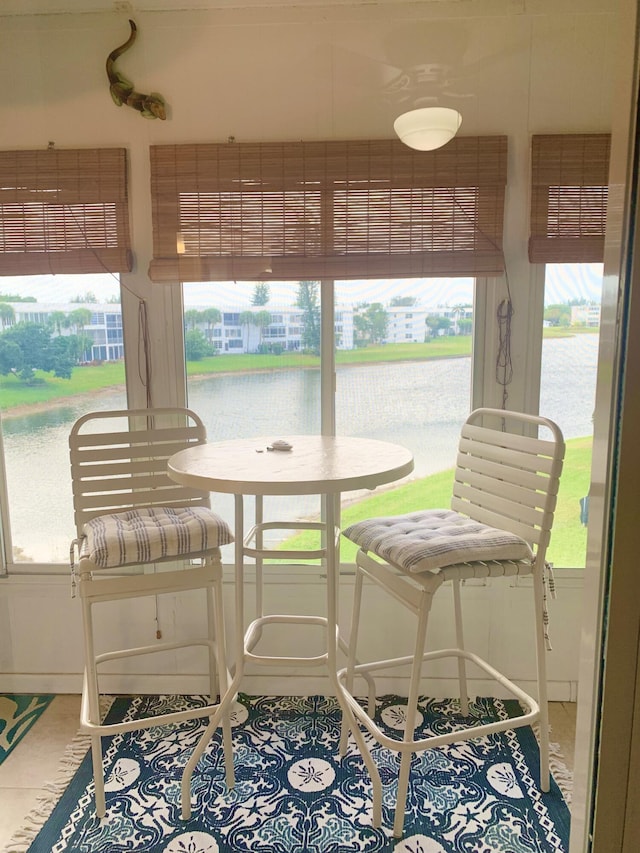 sunroom / solarium featuring a water view and a wealth of natural light