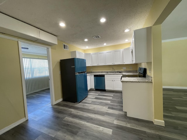 kitchen featuring white cabinetry, black refrigerator, stainless steel dishwasher, and hardwood / wood-style flooring