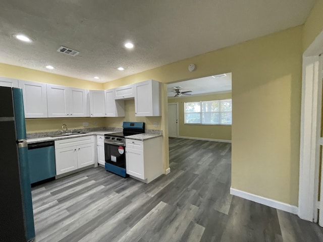 kitchen with sink, ceiling fan, appliances with stainless steel finishes, white cabinetry, and wood-type flooring