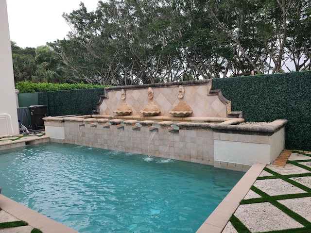 view of pool with a fenced in pool and fence