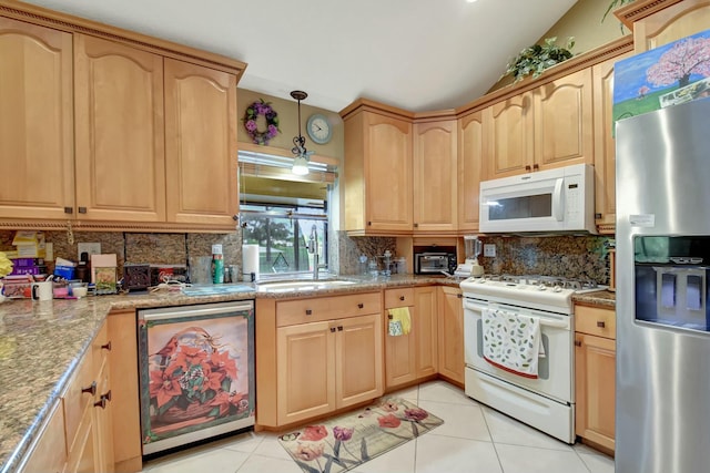 kitchen featuring sink, light tile patterned floors, decorative light fixtures, and appliances with stainless steel finishes