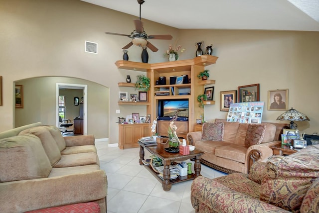 living room featuring ceiling fan, light tile patterned floors, and high vaulted ceiling