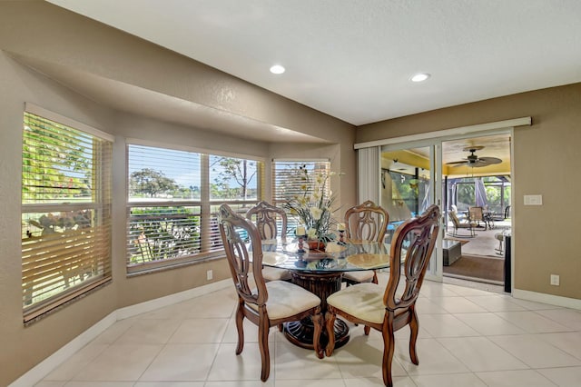 tiled dining space featuring ceiling fan