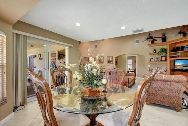 tiled dining area with ceiling fan