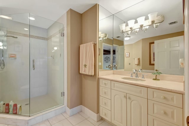 bathroom with tile patterned flooring, vanity, ceiling fan, and a shower with shower door