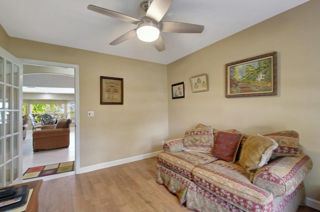 living room with ceiling fan and light wood-type flooring