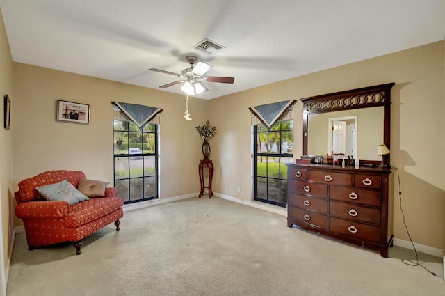 sitting room featuring light carpet and ceiling fan