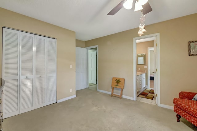 living area with light colored carpet and ceiling fan