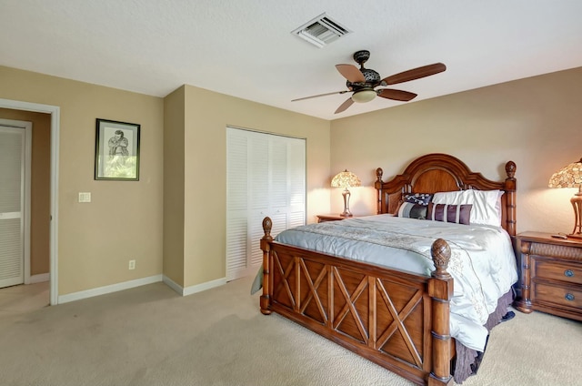 carpeted bedroom with ceiling fan and a closet