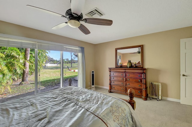 bedroom with access to outside, radiator, ceiling fan, and carpet