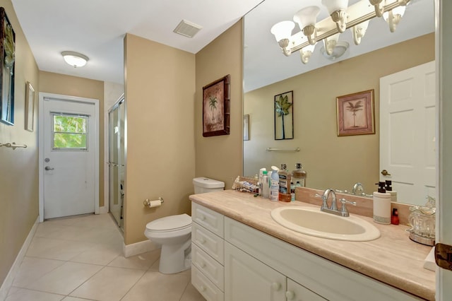 bathroom with tile patterned floors, vanity, an enclosed shower, and toilet