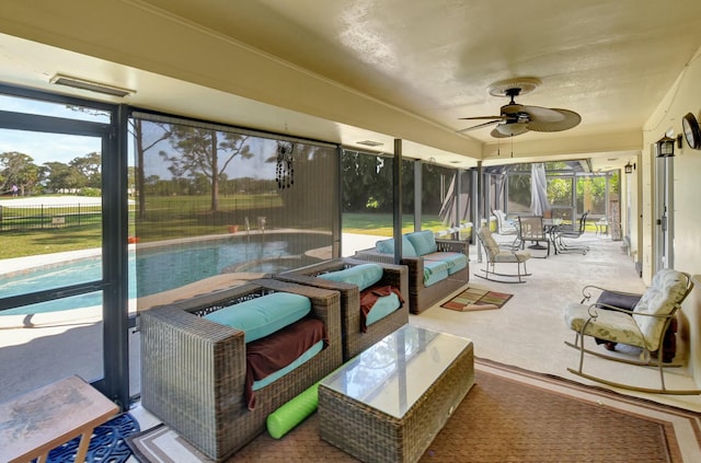 sunroom featuring plenty of natural light and ceiling fan