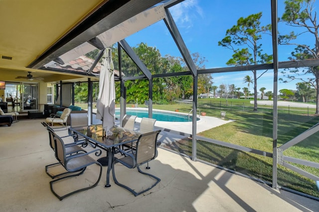 sunroom featuring a wealth of natural light and ceiling fan