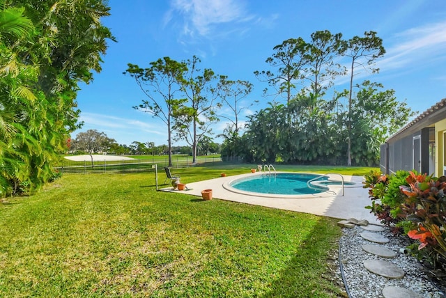 view of pool with a lawn and a patio