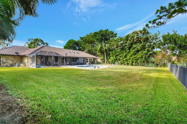 view of yard with a fenced in pool and a lanai