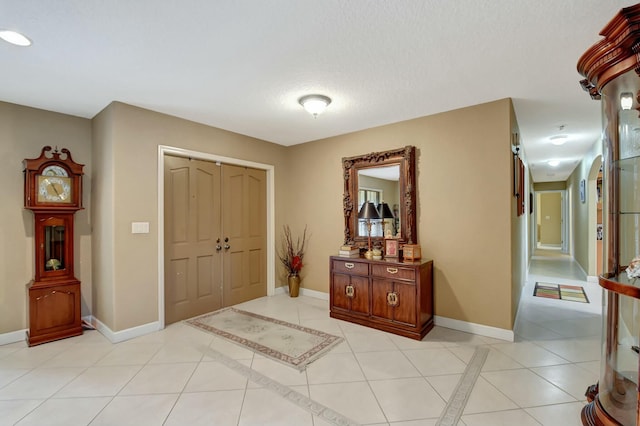 tiled foyer with a textured ceiling