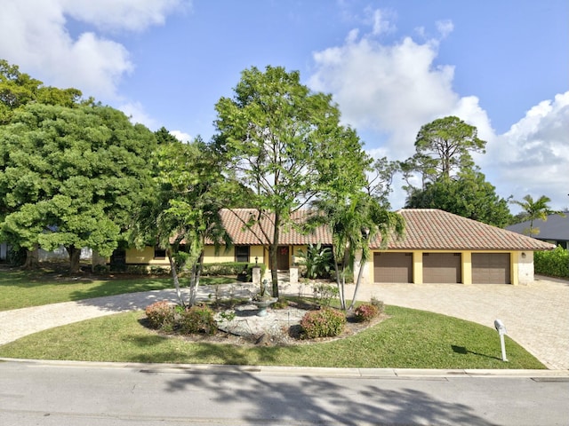 view of front facade with a garage and a front lawn