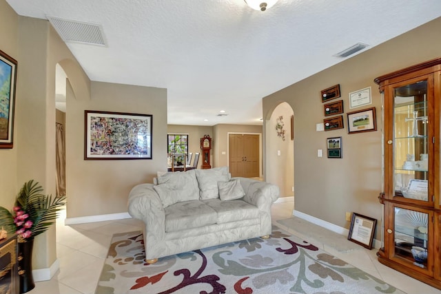 tiled living room with a textured ceiling